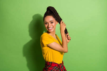 Photo of charming shiny dark skin lady dressed yellow t-shirt hands arm hair tail isolated green color backgroundの写真素材