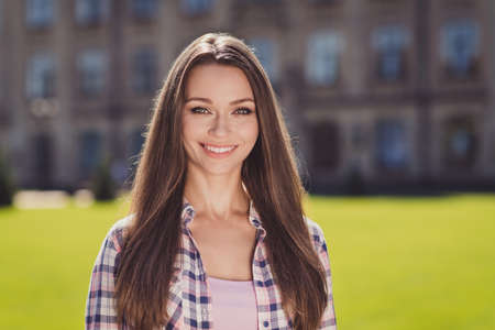 Photo of charming attractive happy young student girl good mood smile outside university in outdoorsの写真素材