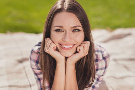 Photo of beaming smile nice young student woman hold hands cheekbones weekend enjoy outside in outdoors parkの写真素材
