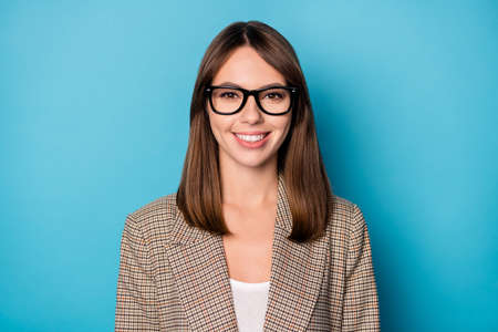 Portrait of nice optimistic brunette lady wear spectacles blazer isolated on vivid blue color backgroundの写真素材