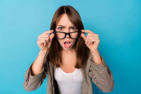 Photo of impressed nice brunette lady wear spectacles brown jacket isolated on vivid blue backgroundの写真素材