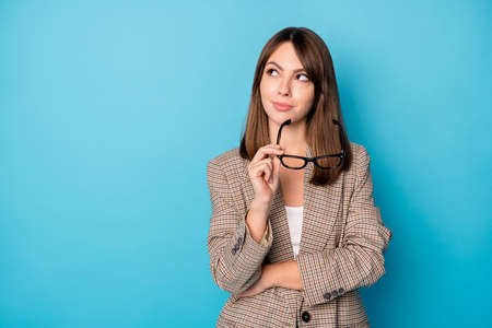 Photo of optimistic nice brunette lady look empty space wear spectacles brown jacket isolated on vivid blue backgroundの写真素材
