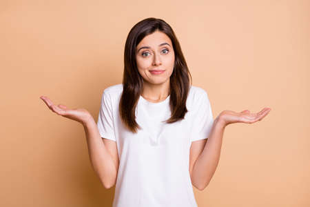 Photo portrait of clueless unsure female student shrugging shoulders wearing casual outfit isolated...