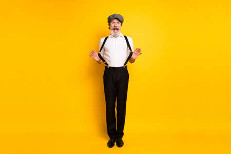 Full body photo of mature man happy positive smile excited hand touch suspenders isolated over...
