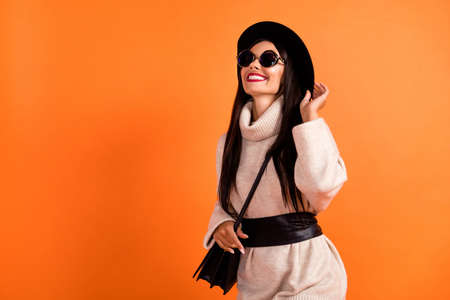 Portrait of attractive cheerful dreamy woman touching hat having fun walk go isolated over bright...