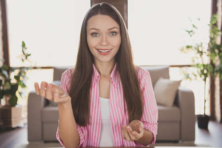 Photo of charming happy nice woman talk web camera online meeting remote freelancer inside home...