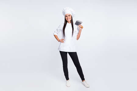 Full body portrait of pretty cheerful girl put arm on waist hold butcher knife isolated on white...