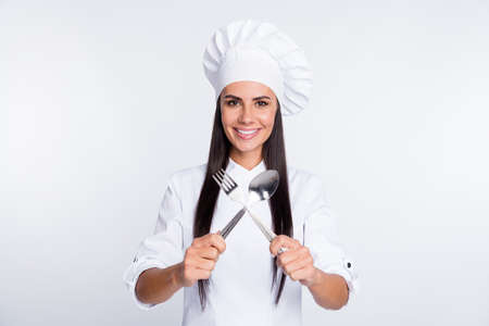 Portrait of attractive positive lady hands hold crossed fork spoon have good mood isolated on white color backgroundの写真素材