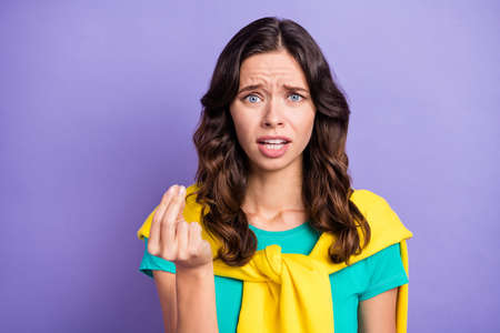 Portrait of lovely miserable angry wavy-haired girl saying pretense bad mood isolated over violet pastel color backgroundの写真素材