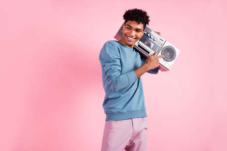 Photo of young excited man happy smile indicate finger retro boombox music isolated over pink color backgroundの写真素材