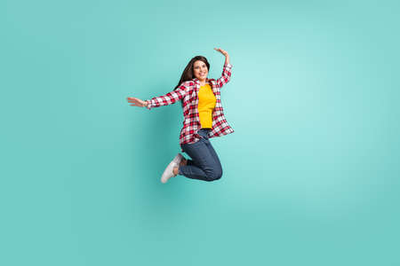 Full length body size view of attractive cheerful girl jumping having fun rest vacation isolated...