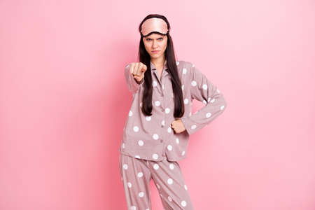 Photo of angry aggressive young woman sleepwear pointing finger you isolated pink color backgroundの写真素材