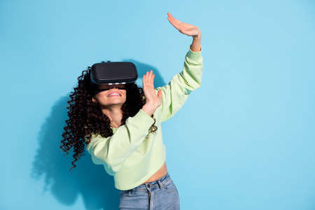 Photo of frightened young lady raise hands defend unexpected reaction isolated on blue color...