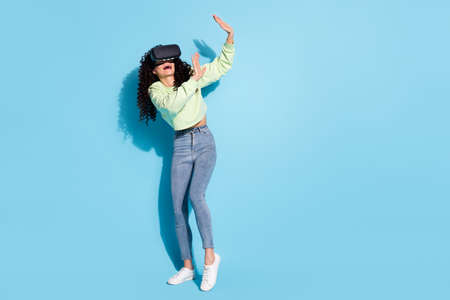 Full length portrait of terrified person try vr raise arms open mouth unbelievable isolated on blue color backgroundの写真素材