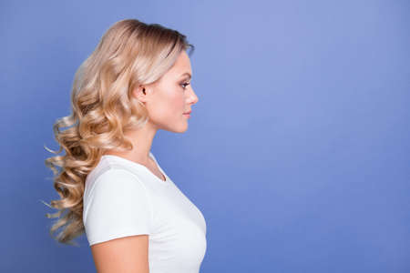 Profile side photo of young serious charming beautiful lovely pretty girl look copyspace isolated on blue color backgroundの写真素材