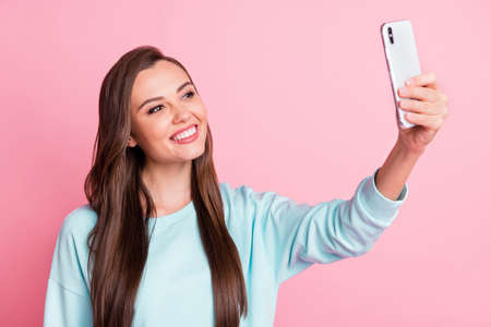 Photo of cute attractive girl take selfie phone wear blue pullover beaming smile isolated on pastel...