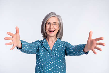 Portrait of attractive friendly cheerful middle-aged lady hugging meeting you good mood isolated...