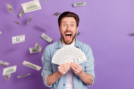 Photo of crazy amazed shocked young man scream happy lottery money isolated on purple color...