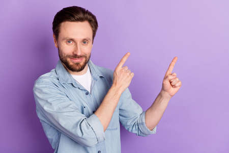 Photo of happy good mood handsome lovely man point fingers copyspace advertisement isolated on...