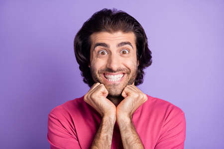 Photo of optimistic nice brunet guy hands cheeks wear pink t-shirt isolated on pastel violet color...