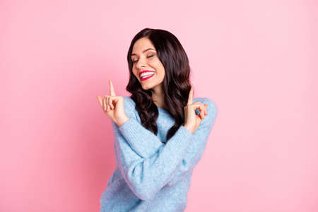 Portrait of excited nice lady closed eyes toothy smile point fingers partying isolated on pink color...