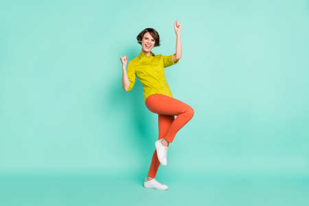 Full length body size view of attractive cheerful girl dancing having fun great success isolated on bright blue color backgroundの写真素材