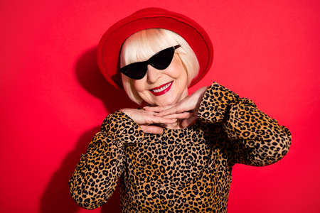 Photo of cool glamour old woman smile wear cool sunglass smile good mood isolated on red color backgroundの写真素材