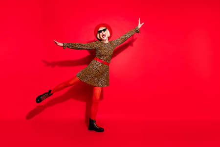 Full length photo of happy nice cheerful old woman hold hands wings fly isolated on red color...