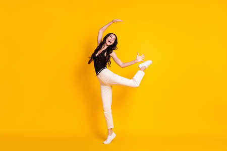 Full size profile side photo of young excited woman happy positive smile playful fooling isolated over yellow color backgroundの写真素材