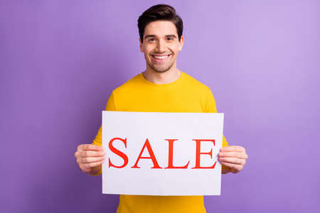 Photo of handsome person smile arms holding sale paper banner isolate don pastel violet color...