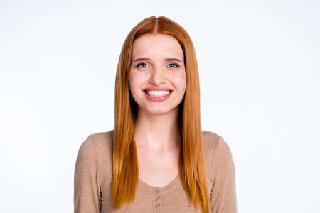 Photo of sweet charming redhair woman beige shirt smiling isolated white color backgroundの写真素材