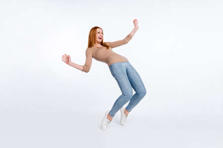 Full length photo of shiny funky ginger lady wear beige shirt smiling dancing isolated white color...