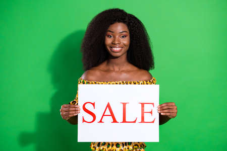 Photo of charming cheerful dark skin person hands hold sale paper card toothy smile isolated on...