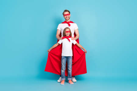 Full body photo of cheerful guy positive pupil wear red hero costume have good mood isolated on blue color backgroundの写真素材