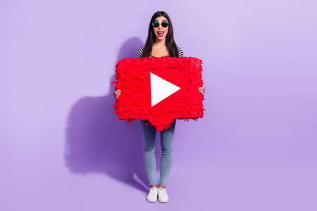 Full size photo of happy excited good mood positive girl hold huge paper play button isolated on purple color backgroundの写真素材