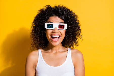 Photo of excited funny dark skin person open mouth unbelievable wear 3d glasses isolated on yellow color backgroundの写真素材