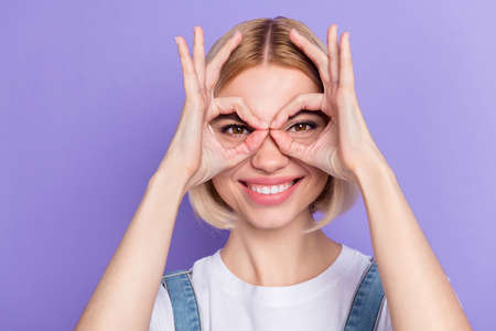 Photo of nice optimistic short hairdo blond lady show okey wear white t-shirt isolated on violet...