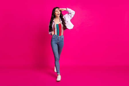Full size photo of impressed brunette nice lady go look wear top jacket jeans sneakers isolated on...