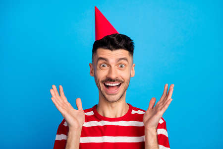 Photo of amazed charming happy man raise palms present expect birthday isolated on pastel blue color...