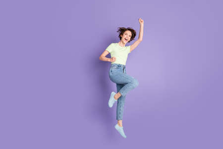 Full length body size view of lovely overjoyed cheerful girl jumping having fun celebrating isolated...