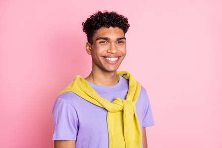 Photo of nice optimistic brunette guy wear t-shirt isolated on pastel pink color backgroundの写真素材