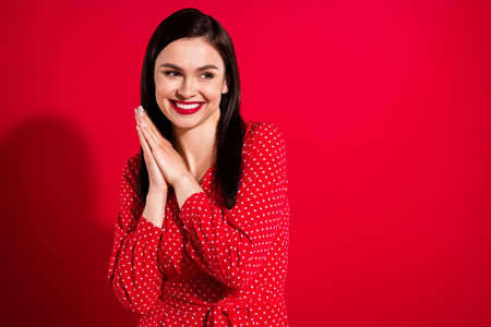 Photo of millennial funny brunette lady look empty space wear red dress isolated on vivid color backgroundの写真素材