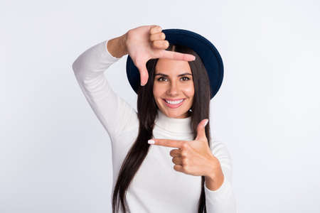 Photo of creative young attractive woman hold hands frame fingers smile isolated on grey color...