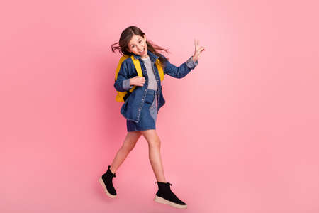 Full length body size photo smiling walking on lessons showing v-sign gestures isolated pastel pink color backgroundの写真素材