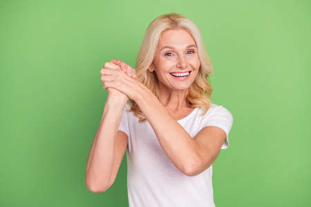 Photo portrait senior woman gesturing like winner overjoyed isolated on pastel green color...