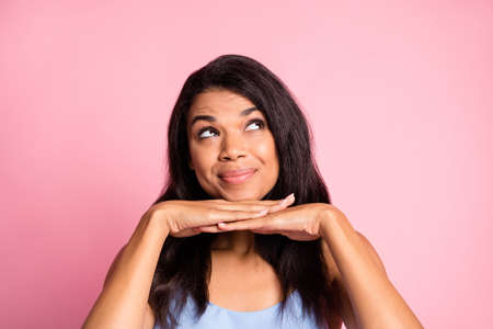 Portrait of optimistic brunette lady hands face look empty space wear blue top isolated on pink...