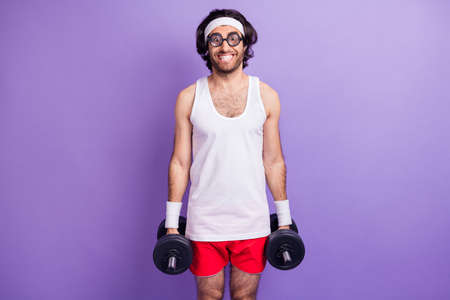 Photo of optimistic brunette guy do sport wear big spectacles white singlet red shirts isolated on lilac color backgroundの写真素材