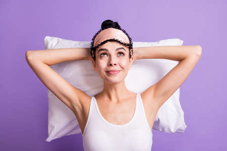 High angle view photo of happy smiling charming girl look up copyspace relaxing isolated on violet color backgroundの写真素材