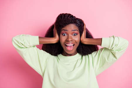 Photo of astonished dark skin girl arm son head open mouth unexpected news isolated on pink color backgroundの写真素材