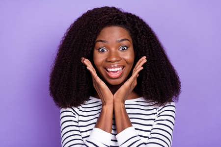 Photo of hooray young lady hands face wear striped sweater isolated on violet color backgroundの写真素材